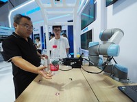 Visitors are visiting an ''adaptive grasping robot'' at the 26th China Beijing International Science and Technology Industry Expo in Beijing...