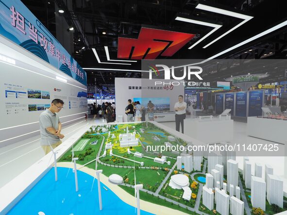 Visitors are visiting the ''sand table model of Eco-energy Complex'' at the 26th China Beijing International Science and Technology Industry...