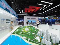 Visitors are visiting the ''sand table model of Eco-energy Complex'' at the 26th China Beijing International Science and Technology Industry...