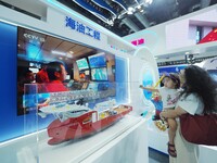 Visitors are viewing a model of ''Offshore Oil 289'' at the 26th China Beijing International Science and Technology Industry Expo in Beijing...