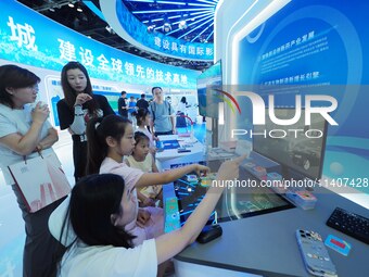 Visitors are experiencing an ''AI intelligent desk'' at the 26th China Beijing International Science and Technology Expo in Beijing, China,...