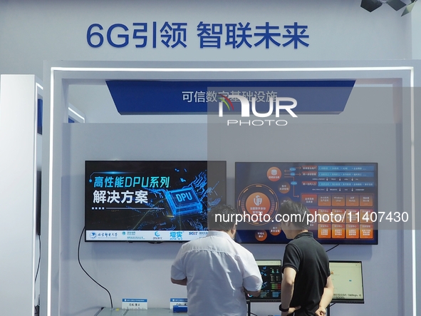 Visitors are visiting the ''Trusted Digital Infrastructure'' at the booth of Beijing University of Posts and Telecommunications at the 26th...