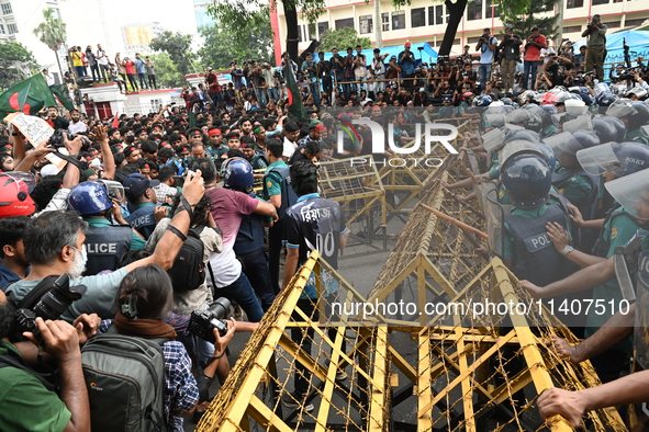 Students are trying to get past police barricades during a march towards the President's house 'Bangabhaban' to submit their memorandum dema...