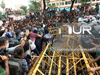 Students are trying to get past police barricades during a march towards the President's house 'Bangabhaban' to submit their memorandum dema...