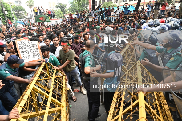 Students are trying to get past police barricades during a march towards the President's house 'Bangabhaban' to submit their memorandum dema...