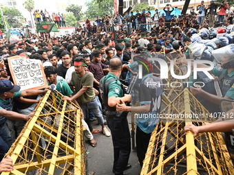 Students are trying to get past police barricades during a march towards the President's house 'Bangabhaban' to submit their memorandum dema...