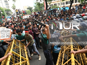 Students are trying to get past police barricades during a march towards the President's house 'Bangabhaban' to submit their memorandum dema...