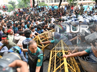 Students are trying to get past police barricades during a march towards the President's house 'Bangabhaban' to submit their memorandum dema...