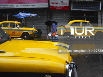 A person is holding an umbrella while walking on the street during the monsoon in Kolkata, India, on July 14, 2024. (