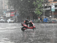 A person is riding an Escooter during the heavy rain in Kolkata, India, on July 14, 2024. (