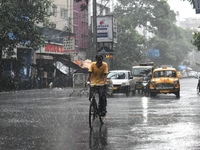 A person is riding his cycle during the heavy rain in Kolkata, India, on July 14, 2024. (