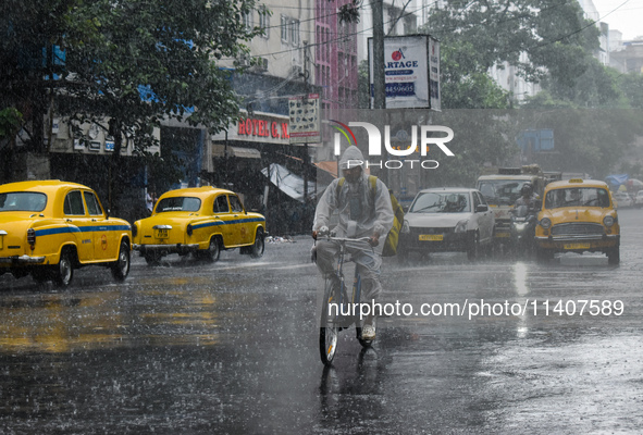 A food delivery person is delivering food during heavy rain in Kolkata, India, on July 14, 2024. 