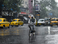 A food delivery person is delivering food during heavy rain in Kolkata, India, on July 14, 2024. (