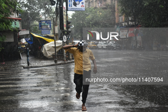 A person is running on the street during the heavy rain in Kolkata, India, on July 14, 2024. 