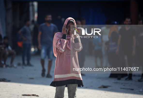 People are checking the destruction at a UN-run school after Israeli bombardment in Nuseirat, in the central Gaza Strip, on July 14, 2024, a...