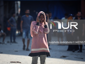 People are checking the destruction at a UN-run school after Israeli bombardment in Nuseirat, in the central Gaza Strip, on July 14, 2024, a...