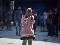 People are checking the destruction at a UN-run school after Israeli bombardment in Nuseirat, in the central Gaza Strip, on July 14, 2024, a...