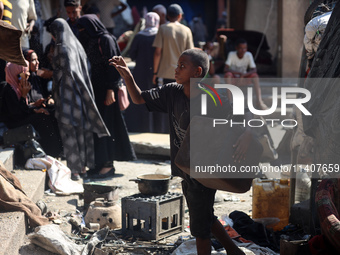 People are checking the destruction at a UN-run school after Israeli bombardment in Nuseirat, in the central Gaza Strip, on July 14, 2024, a...