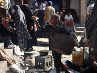 People are checking the destruction at a UN-run school after Israeli bombardment in Nuseirat, in the central Gaza Strip, on July 14, 2024, a...