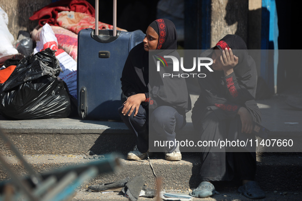 People are checking the destruction at a UN-run school after Israeli bombardment in Nuseirat, in the central Gaza Strip, on July 14, 2024, a...