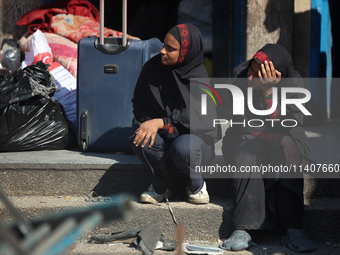 People are checking the destruction at a UN-run school after Israeli bombardment in Nuseirat, in the central Gaza Strip, on July 14, 2024, a...