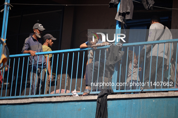 People are checking the destruction at a UN-run school after Israeli bombardment in Nuseirat, in the central Gaza Strip, on July 14, 2024, a...