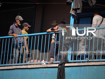 People are checking the destruction at a UN-run school after Israeli bombardment in Nuseirat, in the central Gaza Strip, on July 14, 2024, a...