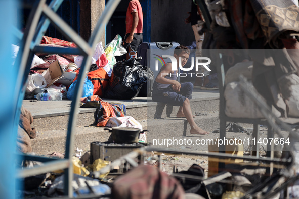 People are checking the destruction at a UN-run school after Israeli bombardment in Nuseirat, in the central Gaza Strip, on July 14, 2024, a...