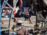 People are checking the destruction at a UN-run school after Israeli bombardment in Nuseirat, in the central Gaza Strip, on July 14, 2024, a...