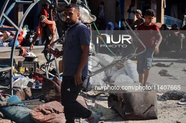 People are checking the destruction at a UN-run school after Israeli bombardment in Nuseirat, in the central Gaza Strip, on July 14, 2024, a...