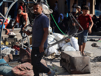 People are checking the destruction at a UN-run school after Israeli bombardment in Nuseirat, in the central Gaza Strip, on July 14, 2024, a...