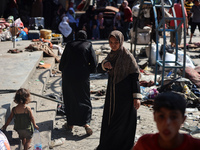 People are checking the destruction at a UN-run school after Israeli bombardment in Nuseirat, in the central Gaza Strip, on July 14, 2024, a...