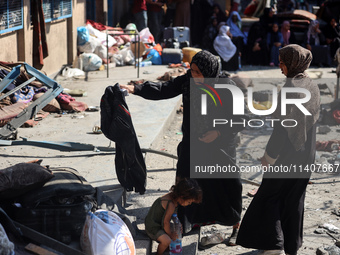 People are checking the destruction at a UN-run school after Israeli bombardment in Nuseirat, in the central Gaza Strip, on July 14, 2024, a...