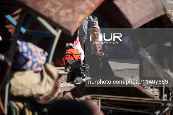 People are checking the destruction at a UN-run school after Israeli bombardment in Nuseirat, in the central Gaza Strip, on July 14, 2024, a...