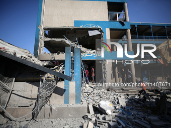 People are checking the destruction at a UN-run school after Israeli bombardment in Nuseirat, in the central Gaza Strip, on July 14, 2024, a...