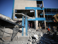 People are checking the destruction at a UN-run school after Israeli bombardment in Nuseirat, in the central Gaza Strip, on July 14, 2024, a...