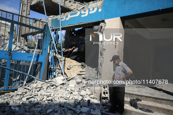 People are checking the destruction at a UN-run school after Israeli bombardment in Nuseirat, in the central Gaza Strip, on July 14, 2024, a...