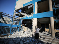 People are checking the destruction at a UN-run school after Israeli bombardment in Nuseirat, in the central Gaza Strip, on July 14, 2024, a...