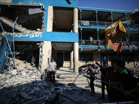 People are checking the destruction at a UN-run school after Israeli bombardment in Nuseirat, in the central Gaza Strip, on July 14, 2024, a...