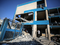 People are checking the destruction at a UN-run school after Israeli bombardment in Nuseirat, in the central Gaza Strip, on July 14, 2024, a...