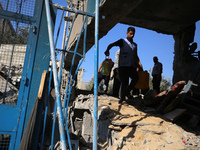 People are checking the destruction at a UN-run school after Israeli bombardment in Nuseirat, in the central Gaza Strip, on July 14, 2024, a...