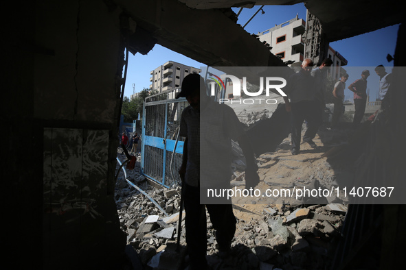 People are checking the destruction at a UN-run school after Israeli bombardment in Nuseirat, in the central Gaza Strip, on July 14, 2024, a...