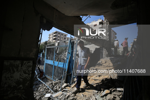 People are checking the destruction at a UN-run school after Israeli bombardment in Nuseirat, in the central Gaza Strip, on July 14, 2024, a...