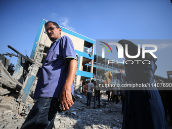 People are checking the destruction at a UN-run school after Israeli bombardment in Nuseirat, in the central Gaza Strip, on July 14, 2024, a...