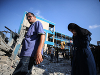 People are checking the destruction at a UN-run school after Israeli bombardment in Nuseirat, in the central Gaza Strip, on July 14, 2024, a...