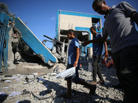 People are checking the destruction at a UN-run school after Israeli bombardment in Nuseirat, in the central Gaza Strip, on July 14, 2024, a...