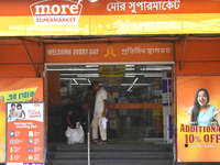 A security person is checking a customer inside a supermarket in Kolkata, India, on July 14, 2024. (