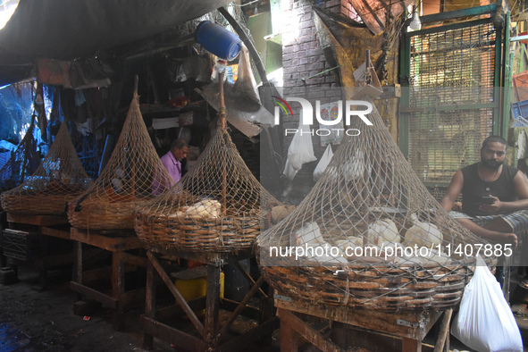 People are selling chicken inside a market in Kolkata, India, on July 14, 2024. 