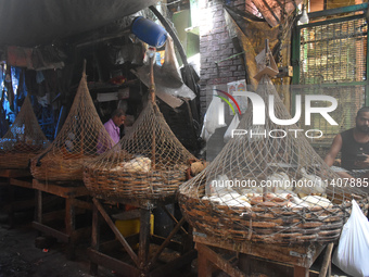 People are selling chicken inside a market in Kolkata, India, on July 14, 2024. (