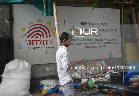 A person is passing next to Aadhar Seva Kendra in Kolkata, India, on July 14, 2024. 